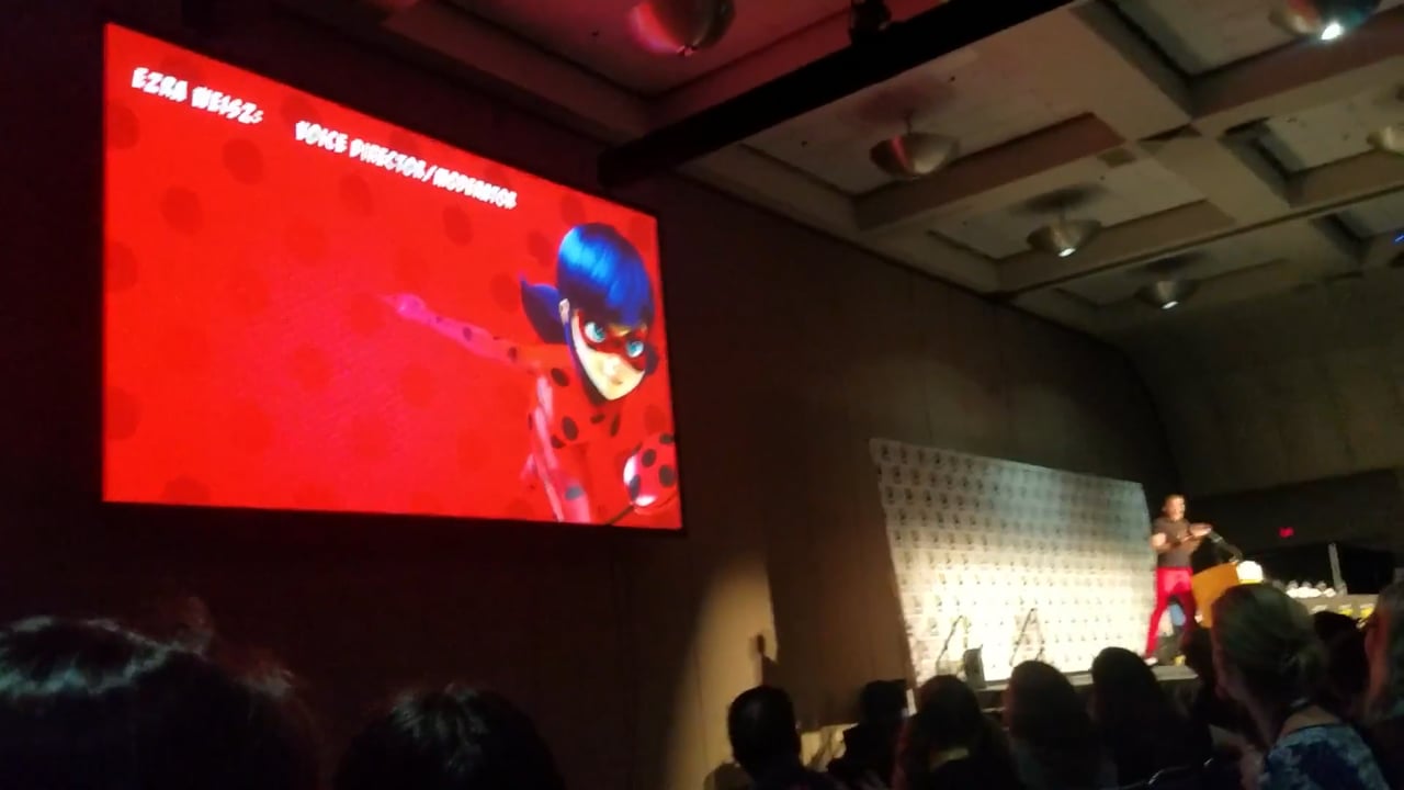 The Miraculous lyric film playing on the large screen above the panel and audience at San Diego Comic-Con